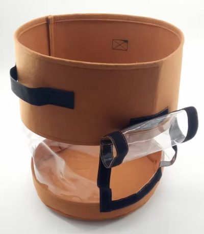 Grow24-Green fabric potato grow bag with clear harvest window, Velcro flap, and sturdy handles showing potatoes growing inside